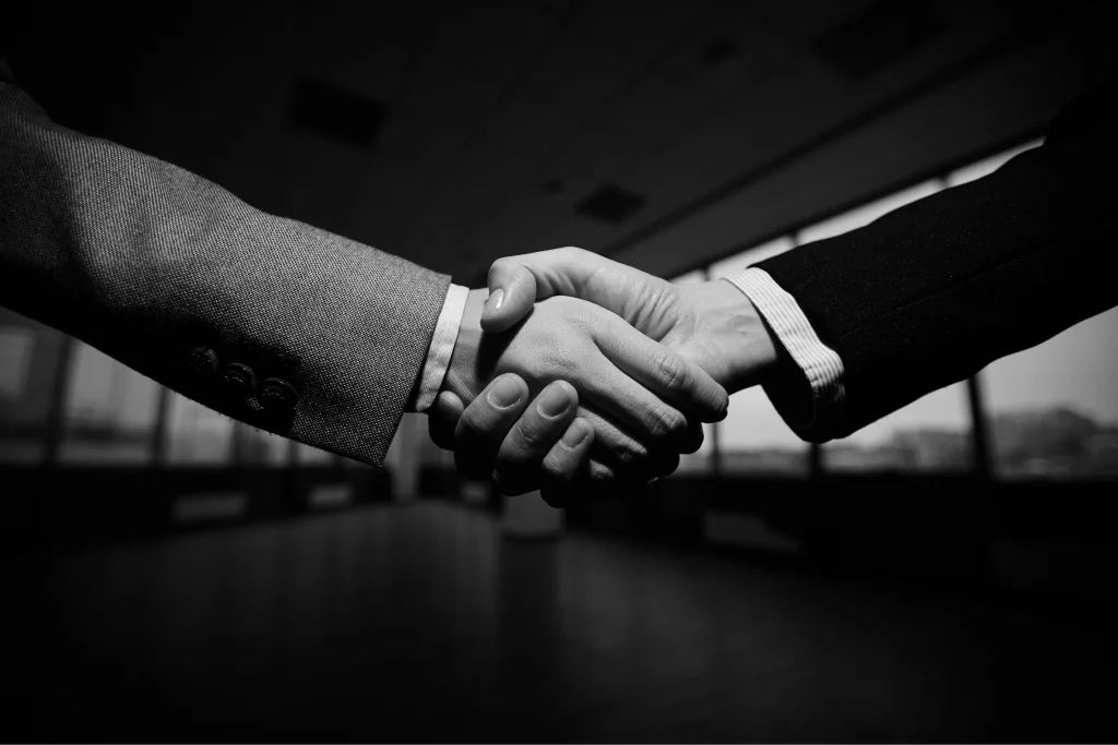 Two people shaking hands in an office
